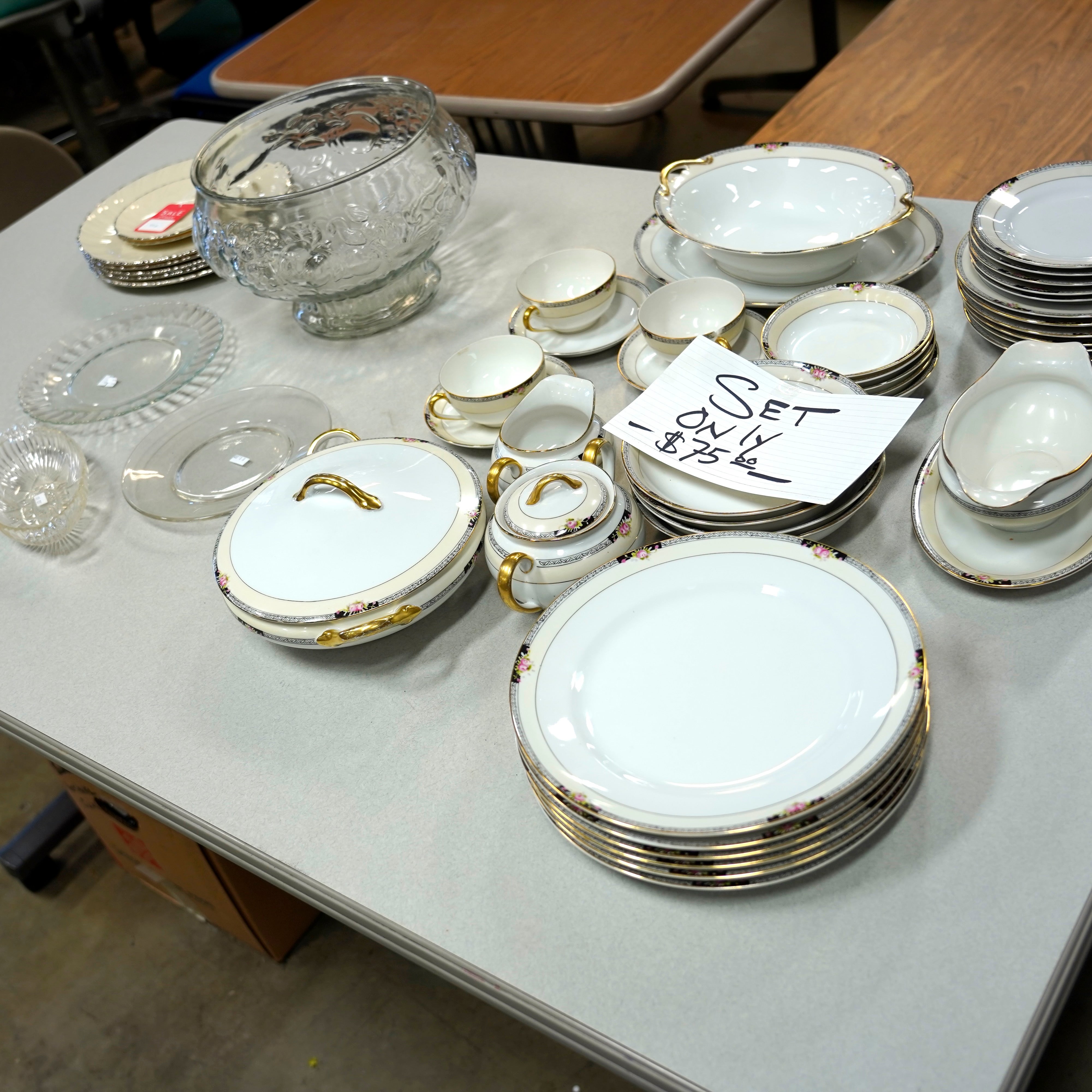 A set of glassware, including dinner and dessert plates, a punch bowl and glasses.