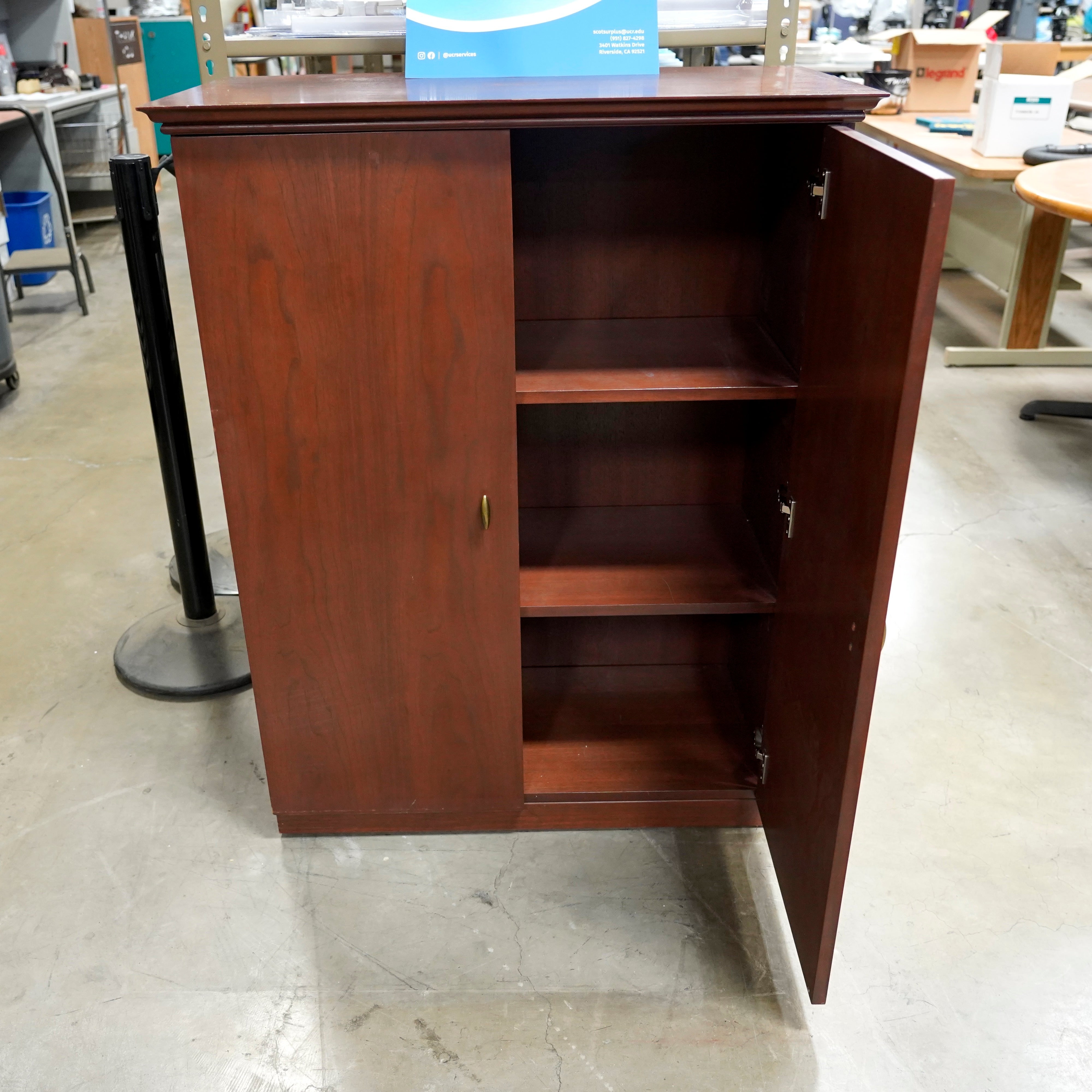 A two-door, three-shelf wooden cabinet for storing all your new glassware.