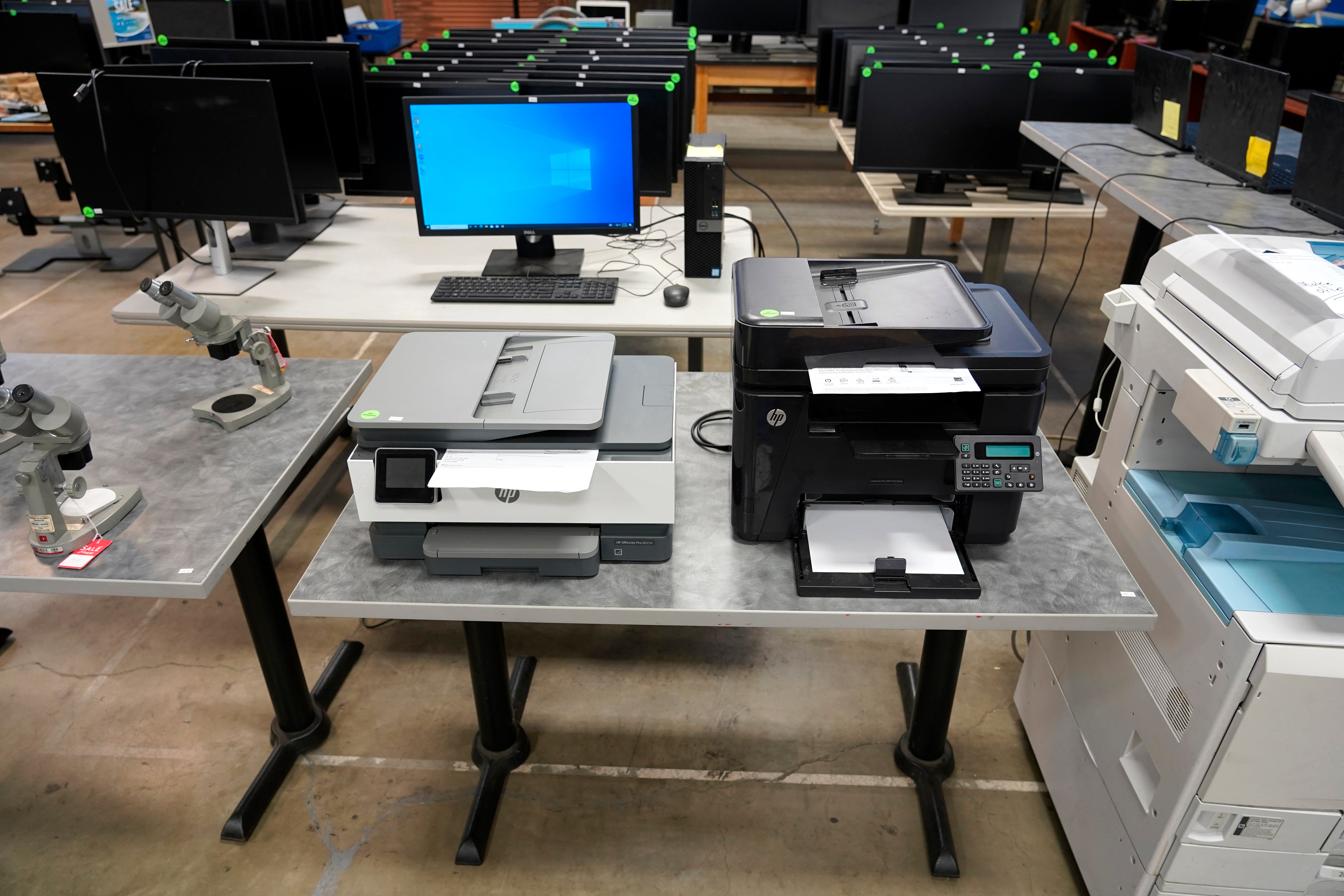 2 HP desktop printers on a table.