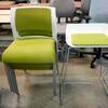 Bright green and white chairs and high-top stools.