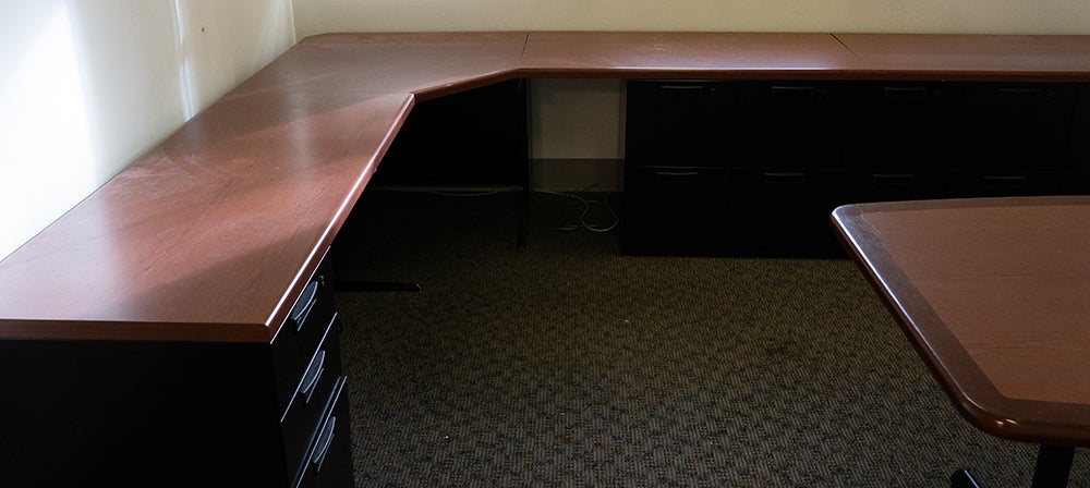 large L-shaped wood desk with extra wood table